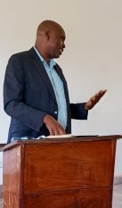 The fomer Njeru Municipality Town Clerk Mr. William Kamara giving his last speech on the handover ceremony to the new  Municipality Town Clerk 